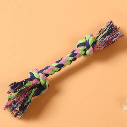 A braided rope dog toy. The rope is made of natural materials and is knotted tightly to prevent unraveling. The toy is lightweight and easy for dogs to carry around.